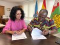 La alcaldesa ceense, Margarita Lamela, y el párroco  Desire Kouakou Tanoh, firmando el acuerdo