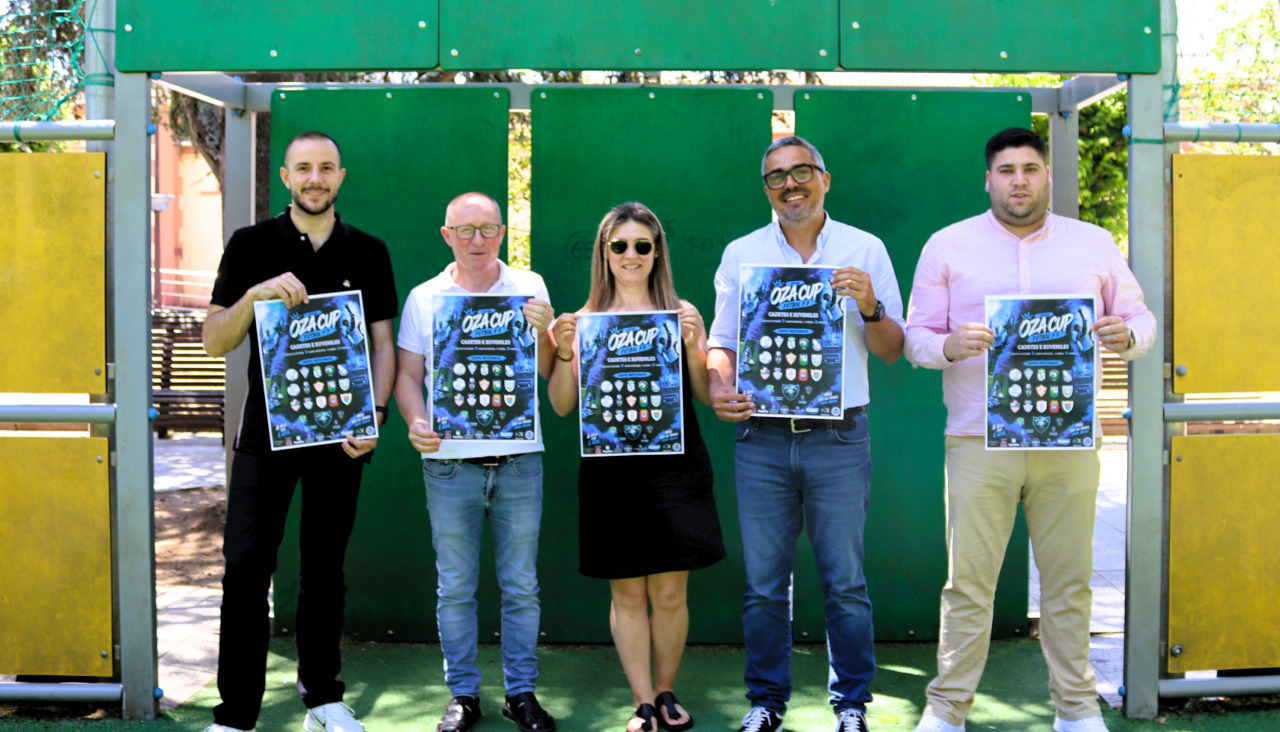 Los representantes del Concello de Carballo y de la SD Oza con el cartel del torneo